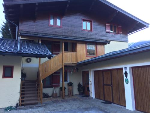 a large wooden house with a wooden garage at Ferienhaus Nationalpark in Neukirchen am Großvenediger