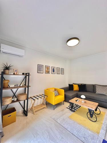 a living room with a couch and a table at Blue Cozy Nest in Rhodes Town