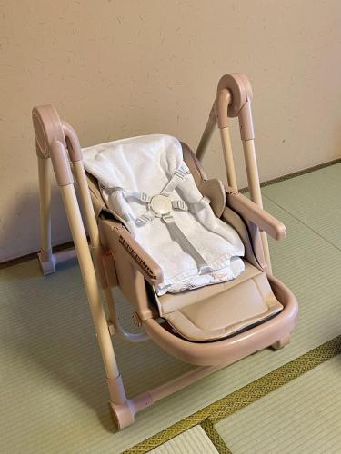 a wooden rocking chair sitting on the floor at Kyoto Higashiyamaso in Kyoto