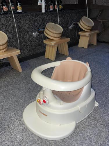 a toy toilet in a room with three tables at Kyoto Higashiyamaso in Kyoto