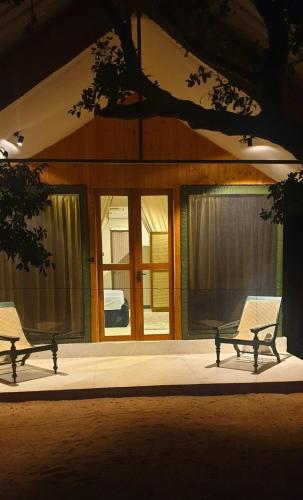 a couple of benches sitting in front of a house at Enchanted Escapes Yala in Yala