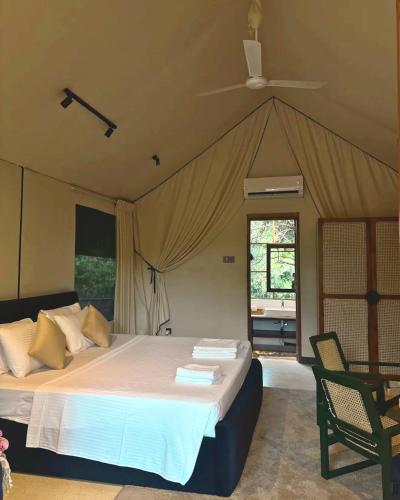 a bedroom with a large bed in a tent at Enchanted Escapes Yala in Yala