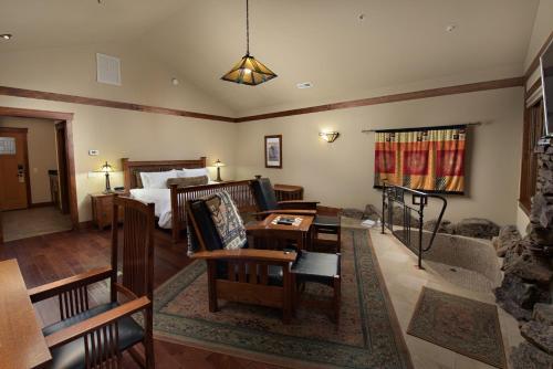 a living room with a bed and a couch and a table at FivePine Lodge in Sisters