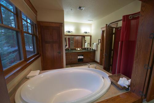 a large bathroom with a large tub and a shower at FivePine Lodge in Sisters