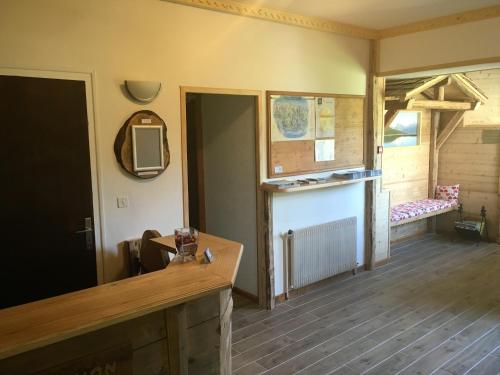 a living room with a television and a room with a table at Hotel Le Soly in Morzine
