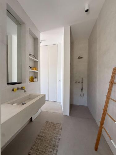 a bathroom with a large sink and a mirror at ARETI Horizon in Kástron