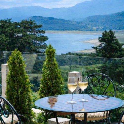 two glasses of white wine sitting on a table at Katalina Resort in Tsigov Chark