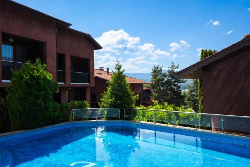 a swimming pool in the backyard of a house at Katalina Resort in Tsigov Chark