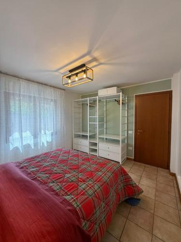 a bedroom with a bed with a red blanket at Villa Augusta in Auronzo di Cadore