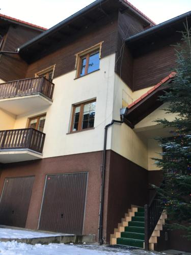 a house with two balconies on the side of it at Apartament Patryk in Szklarska Poręba