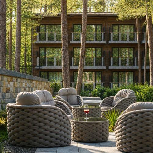 a group of wicker chairs and a table in front of a building at Brentas Spa Resort in Tsigov Chark