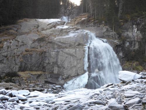 a waterfall on the side of a rocky mountain at Ferienhaus Nationalpark in Neukirchen am Großvenediger