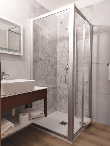 a bathroom with a shower and a sink at New Garden in Nago-Torbole
