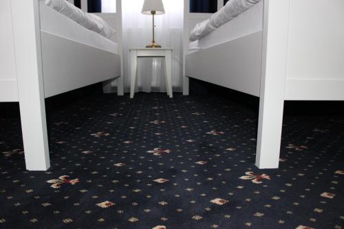 a hallway with two bunk beds and a table at Hotel Amadeus in České Budějovice