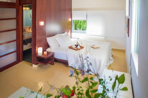 a hotel room with a bed and a window at Nereids Apartments in Sitia