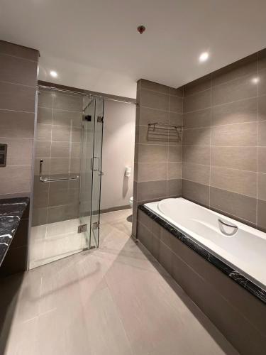 a bathroom with a bath tub and a shower at Bow Luxury 3 in Danang