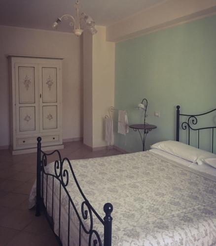 a bedroom with a bed and a dresser in it at Casa Vacanze Il Castello in Pescina