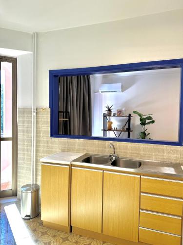 a bathroom with a sink and a blue mirror at Blue Cozy Nest in Rhodes Town
