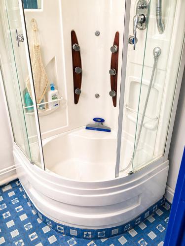 a shower with a glass door in a bathroom at Bel appart vue lac in La Grande Motte