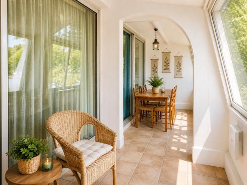a porch with a table and chairs and a window at Bel appart vue lac in La Grande Motte