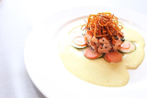 a plate of food with seafood on a white plate at Alta Las Palomas Hotel in San José