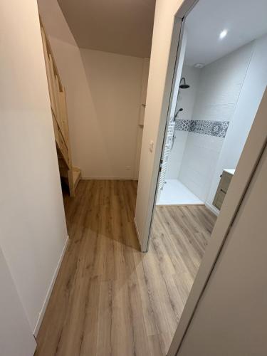 an empty room with a door and wooden floors at LONI Expériences moderne emplacement idéal in Challans