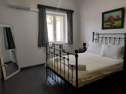 a bedroom with a black bed and a window at MAFILVI Panorama in Chrousa