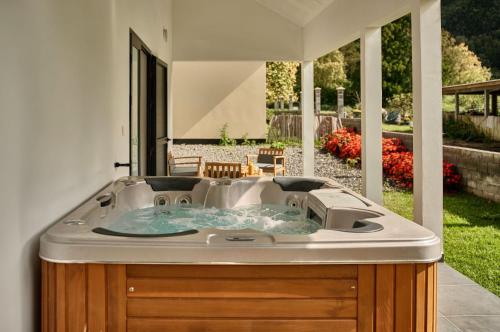 a jacuzzi tub in the backyard of a house at Le Clos des Remparts - 8 pers - Cascades & Nature in La Plaine des Palmistes