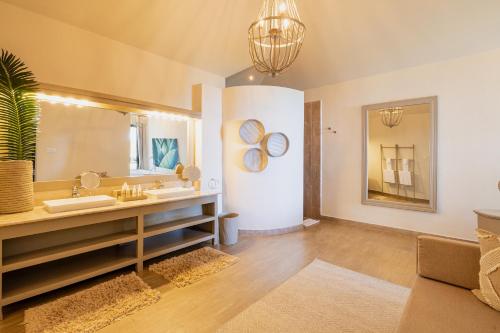 a bathroom with a sink and a mirror at Zawadi Hotel, Zanzibar in Michamvi