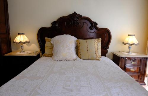 a bedroom with a large bed with two night stands at Gods Barn House in Viana do Castelo