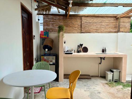 a table and chairs in a room with a table and a counter at Ayu Homestay - Room 3 in San Isidro