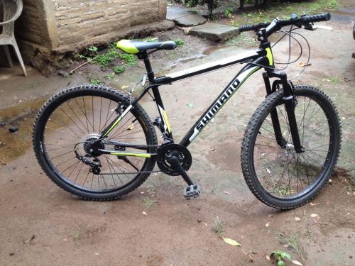 a black bike parked on the ground at B&B, family run homestay, Hospedaje La Penita in Altagracia