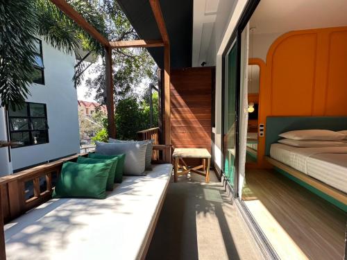 a guest bedroom with a bed and a balcony at Banlansuan Resort in Cha Am