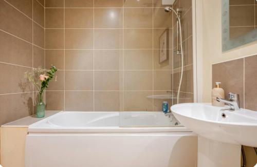 a bathroom with a tub and a sink at Sequoia Tree in Belfast