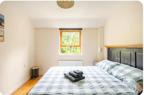 a bedroom with a bed with two towels on it at Sequoia Tree in Belfast