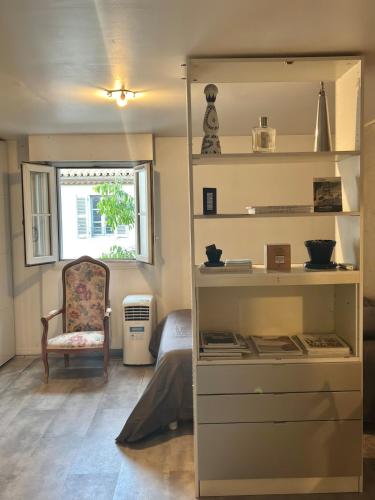 a room with a book shelf and a chair at Central Studio - Port & Lices walkable - Parking in Saint-Tropez