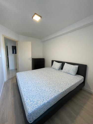 a bedroom with a bed with two pillows on it at The Waves in Ostend