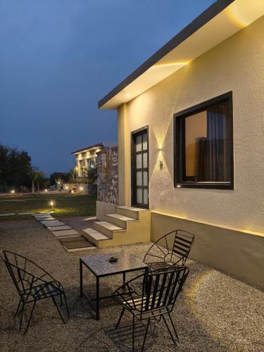 two chairs and a table in front of a building at Jawai-e-khaas in Bijāpur
