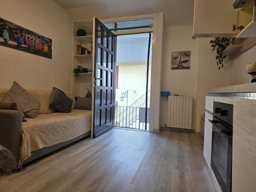 a living room with a couch and a sliding glass door at Nido Ticino in Bernate Ticino