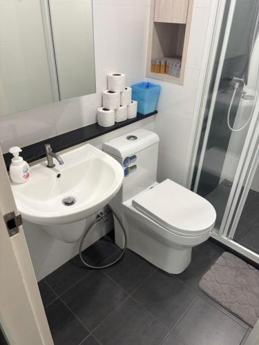 a bathroom with a toilet and a sink and a shower at Sukhumvit​ 101 in Phra Khanong