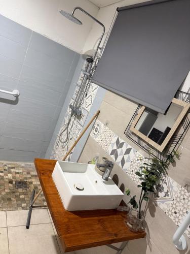 a bathroom with a sink in a room at Kay Yvette in Saint-Pierre