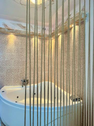 a cage with a tub in a bathroom at Melis Studios in Kallithea Halkidikis