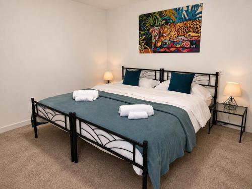 a bedroom with a large bed with two towels on it at Villa Greif Pineta Apartment in Lignano Sabbiadoro