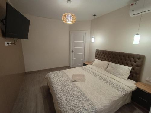 a bedroom with a large bed with a white comforter at Воскресенская 12 Евро in Dnipro