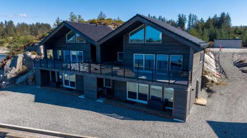 an aerial view of a house with glass at Eksklusiv Rorbu - Havblikk 1 - Båtutleie in Bekkjarvik