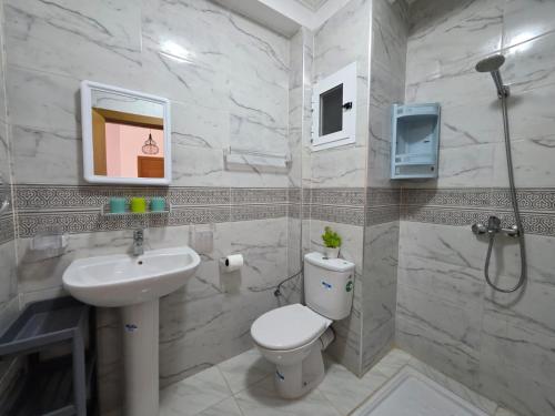 a bathroom with a toilet and a sink at Appartement sur Mer in El Arba de Trougout