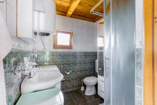 a bathroom with a sink and a toilet at Seaview Chalet in Herceg-Novi