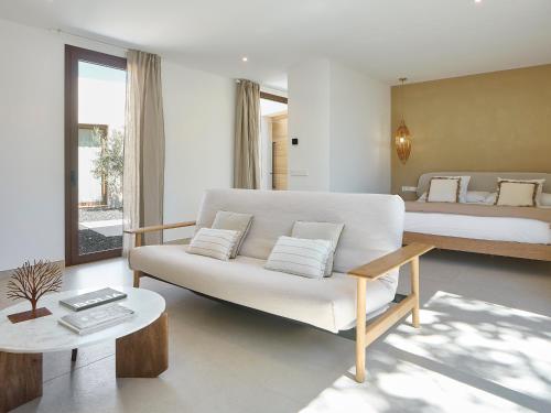 a living room with a couch and a bed at Villa Calella Brava in Calella de Palafrugell