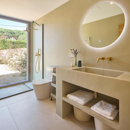 a bathroom with a sink and a mirror at Villa Calella Brava in Calella de Palafrugell