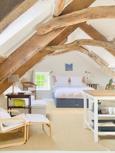 a bedroom with a bed in a room with wooden ceilings at The Attic Apartment, Quay Street Studios Cardigan in Cardigan
